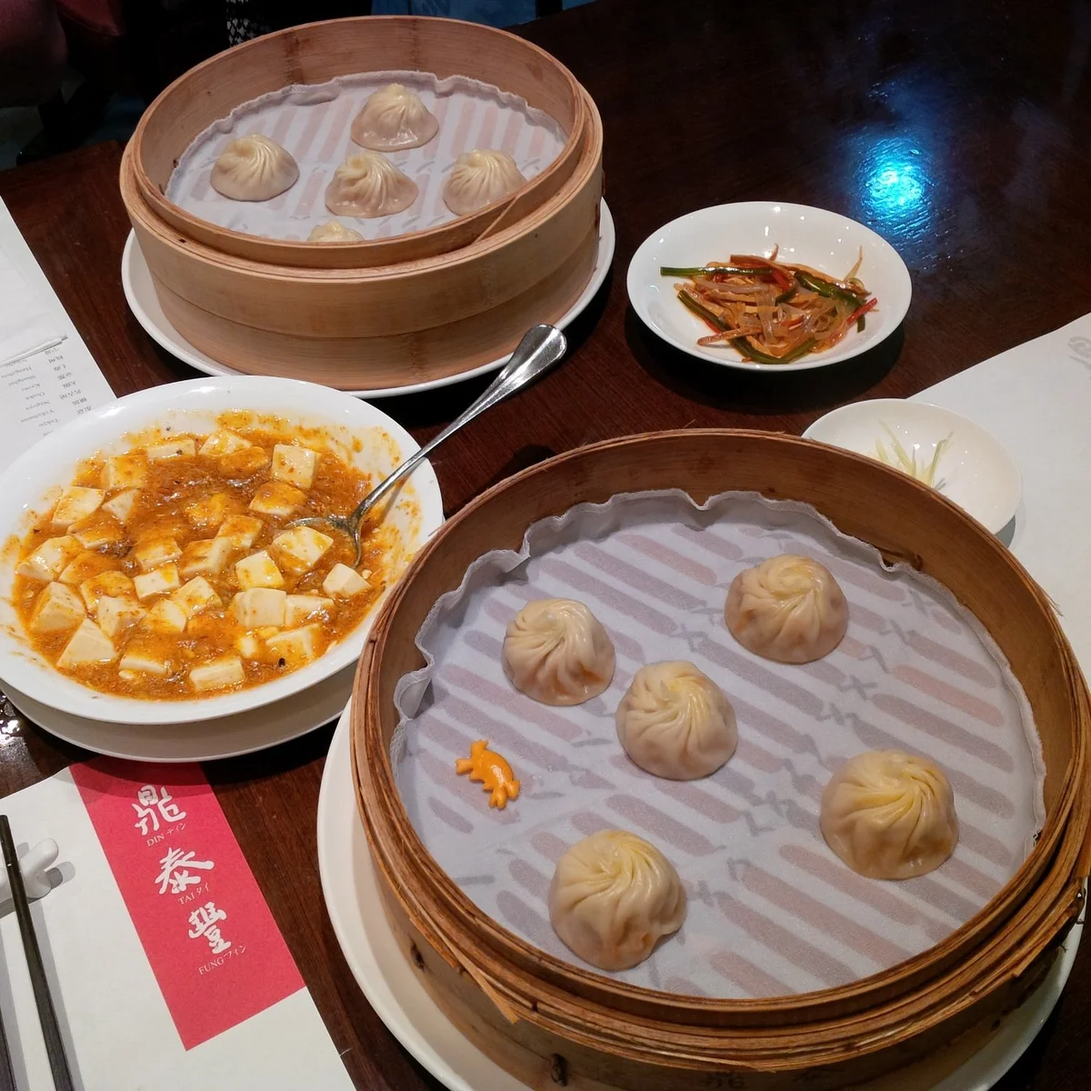 The legendary xiaolongbao — exactly 18 folds per dumpling, each one a perfect bite of broth and pork
