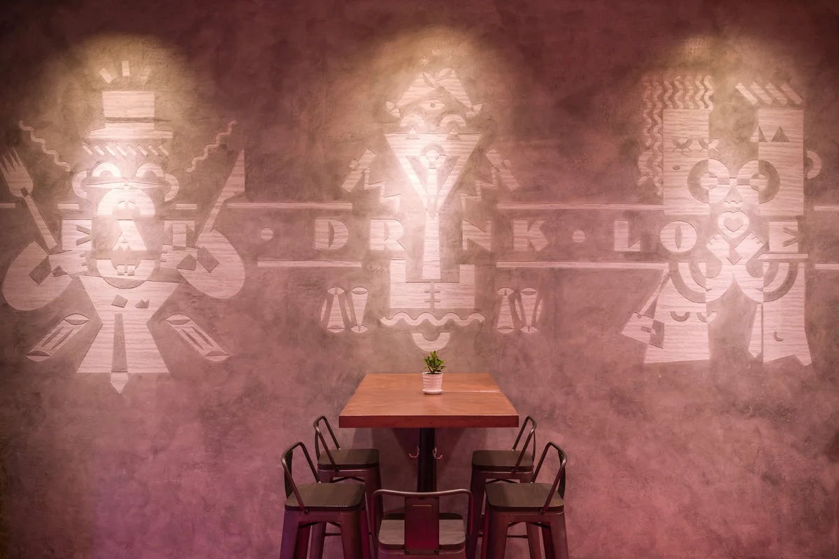 The iconic 'Eat-Drink-Love' neon sign captures Funkadeli's philosophy — the ground-floor bar is where the aperitivo magic happens