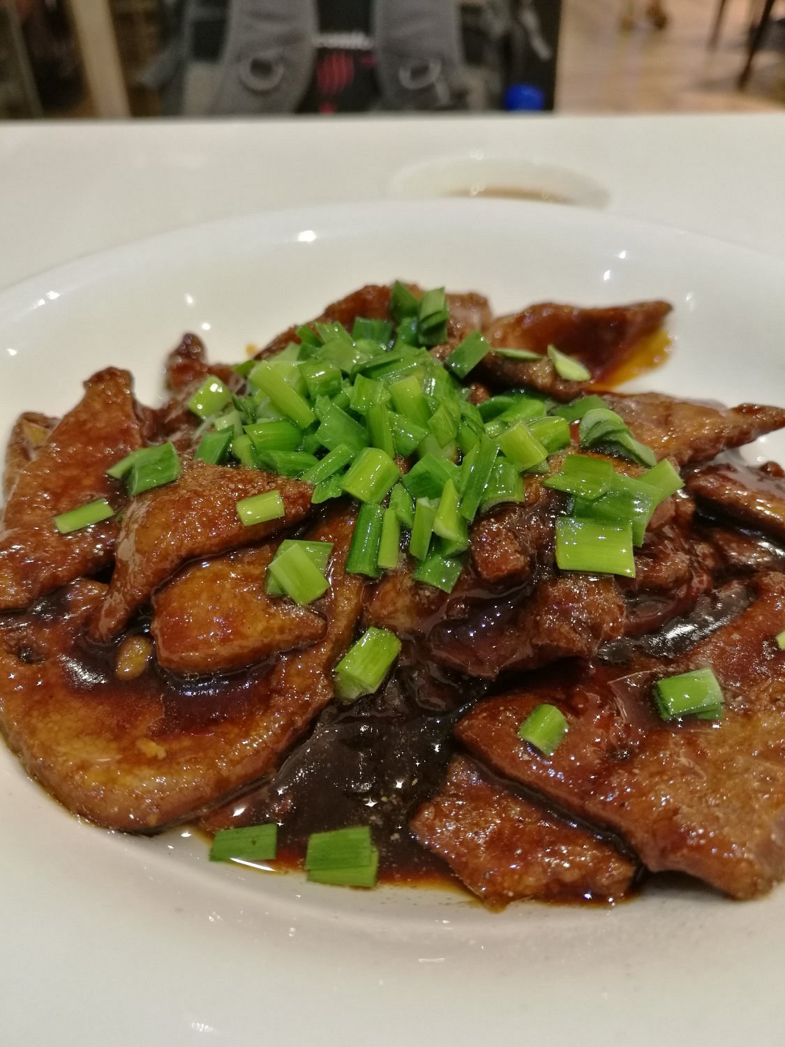 The legendary鲜肉月饼 (fresh pork mooncake) — flaky, golden pastry encasing a juicy, savory-sweet pork filling, straight from the oven