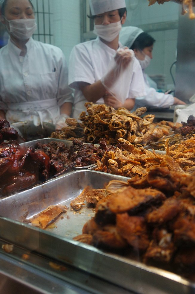 A spread of classic cold dishes — smoked fish, braised duck, and soy-marinated delicacies that define the Shanghainese table