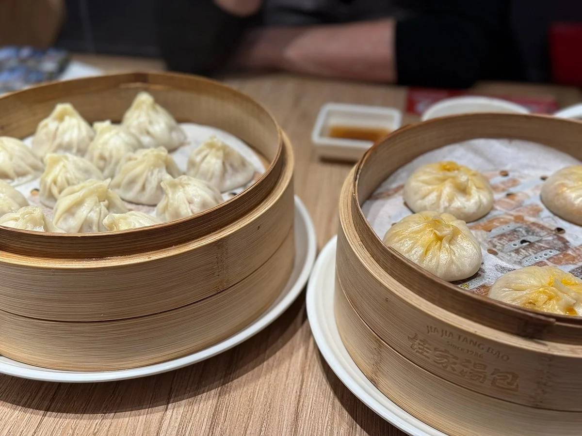 The legendary crab roe and pork xiaolongbao — thin skin, rich broth, perfect pleats