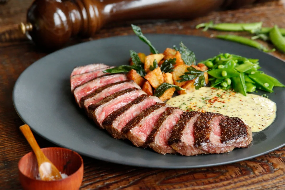 M7 roasted beef striploin — perfectly charred exterior giving way to tender, marbled Wagyu