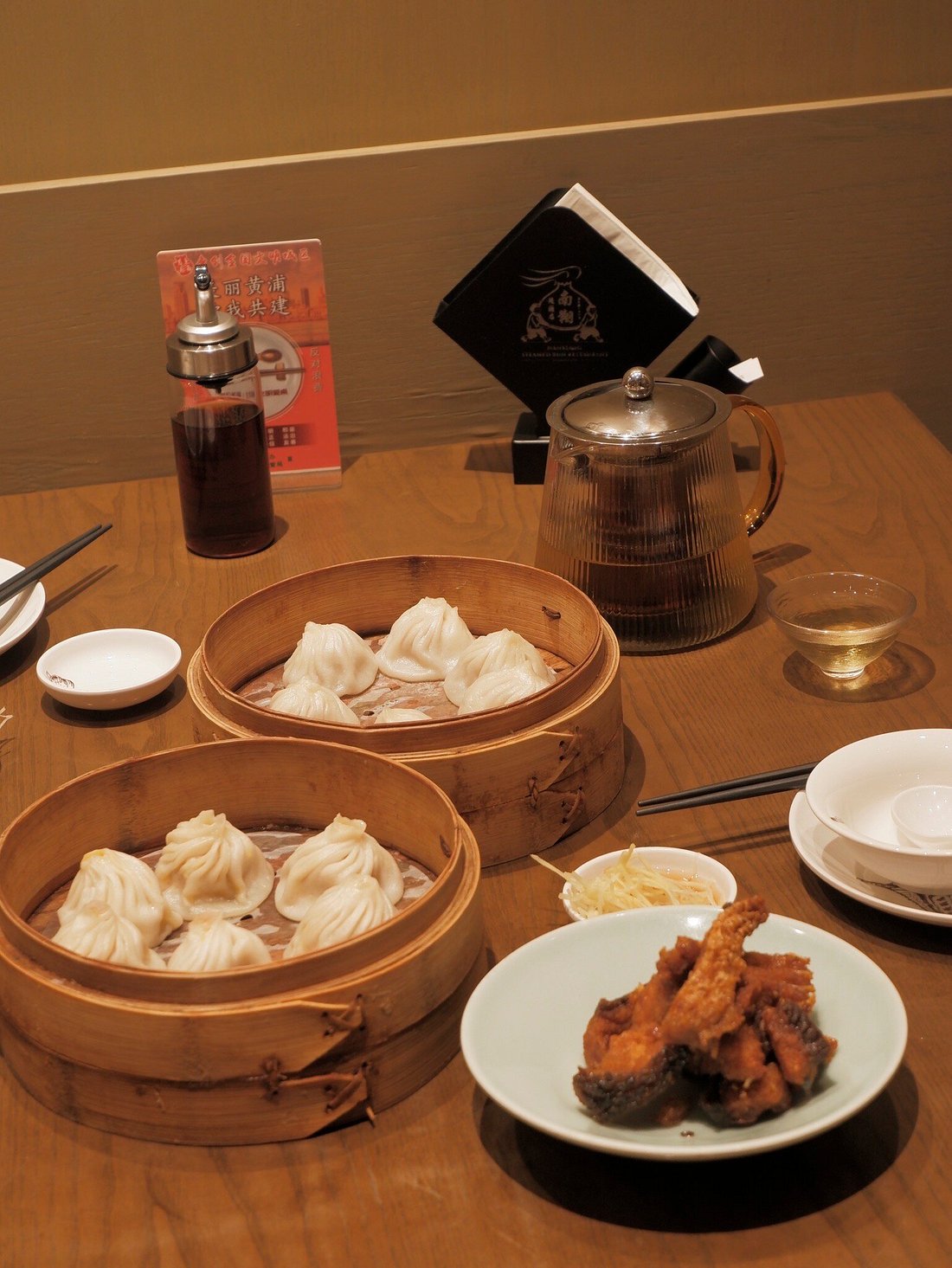 Crab roe xiaolongbao — the premium upgrade, golden crab roe enriching each dumpling with briny sweetness