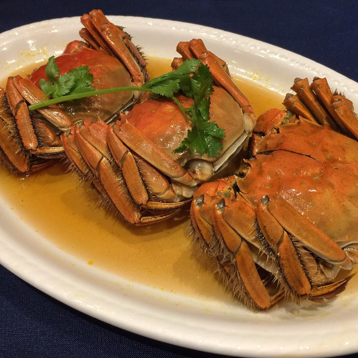 Classic Benbang dishes — tea-smoked fish, drunken chicken, crab roe tofu — served family-style